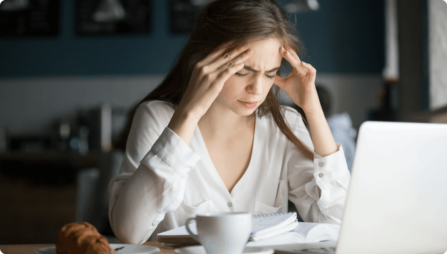 Woman experiencing headache and nausea symptoms linked to binocular vision dysfunction