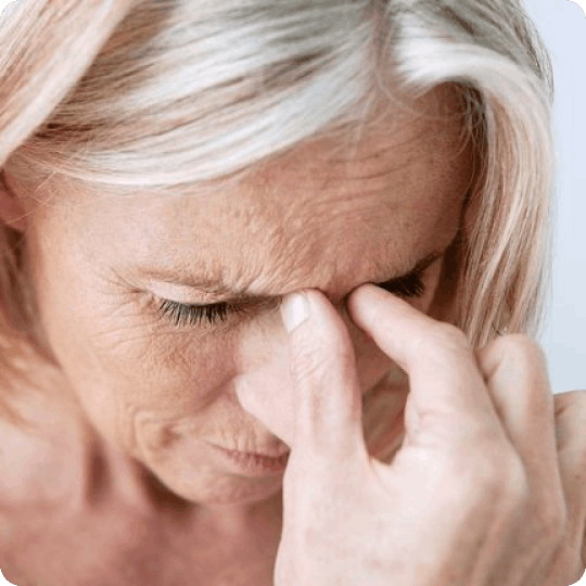 Woman experiencing headache and eye strain symptoms associated with binocular vision dysfunction