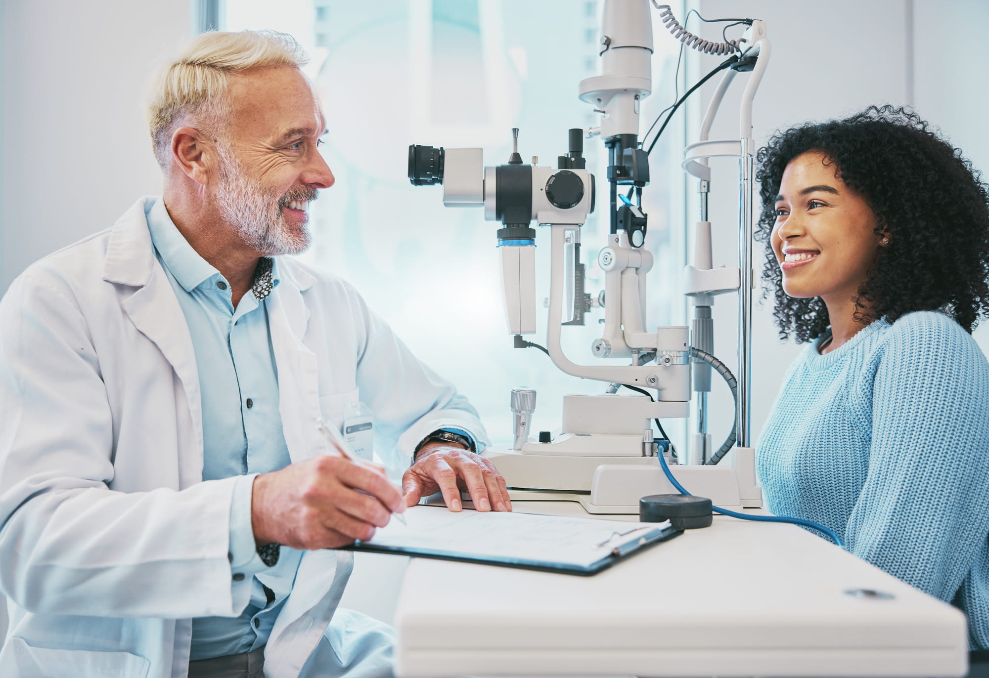Eye exam, consulting and smile with doctor and black woman for healthcare, ophthalmology and medica.