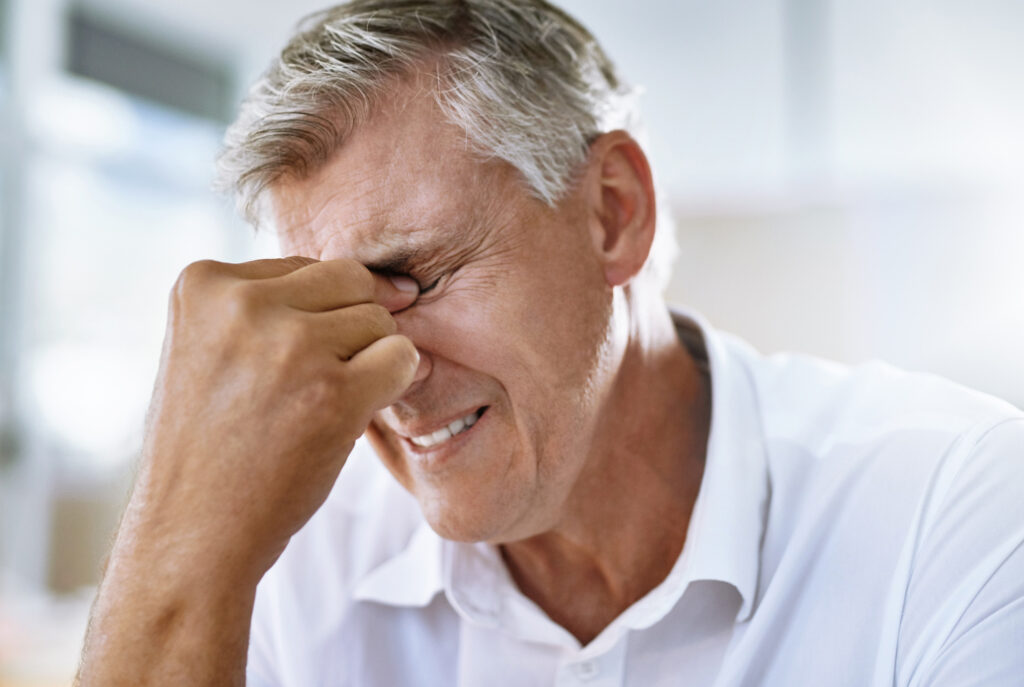 Man suffering from eye pain